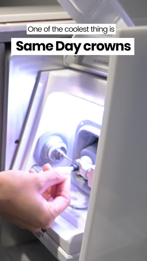 A hand operates a dental milling machine under bright light, crafting a crown. Text overlay reads One of the coolest thing is Same Day crowns.